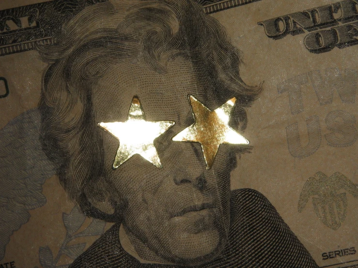 a pograph of a dollar bill with three shiny stars on it