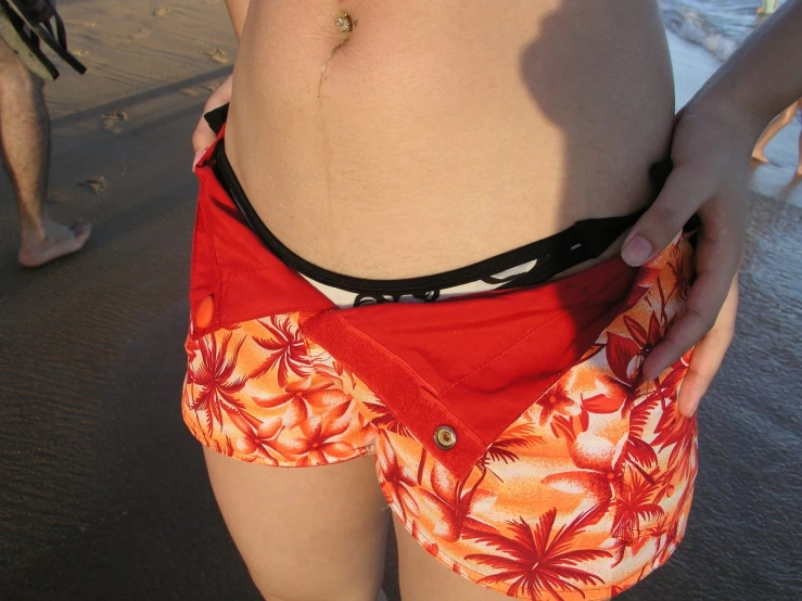 a woman standing in the sand while wearing her underwear