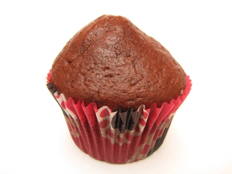 a chocolate cupcake sitting on top of a red and white cupcake liner