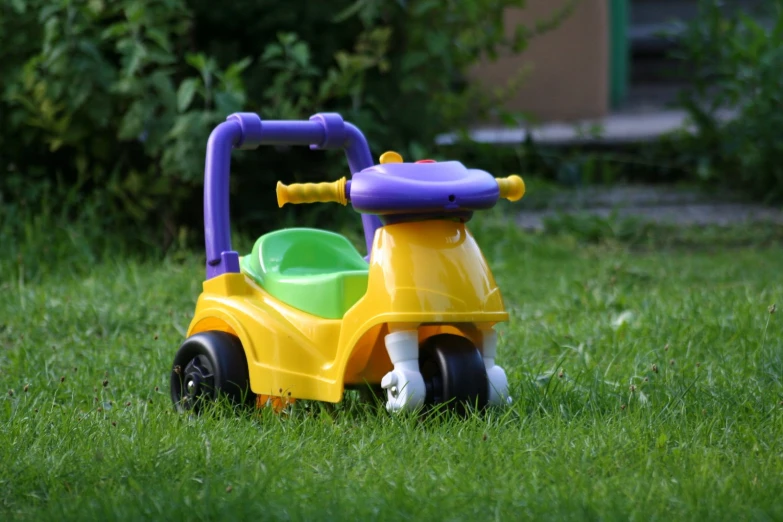 a toy motorcycle is on the grass by itself