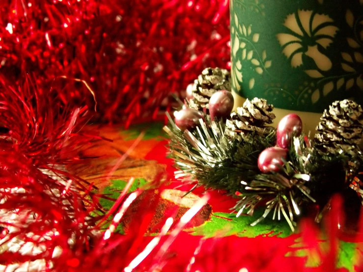 a picture of christmas decorations and candles in the snow