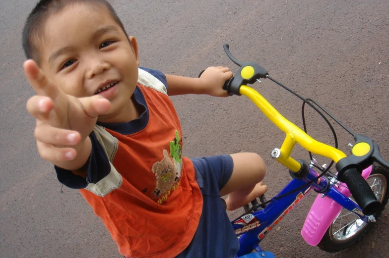 a  with a red vest riding on a bike