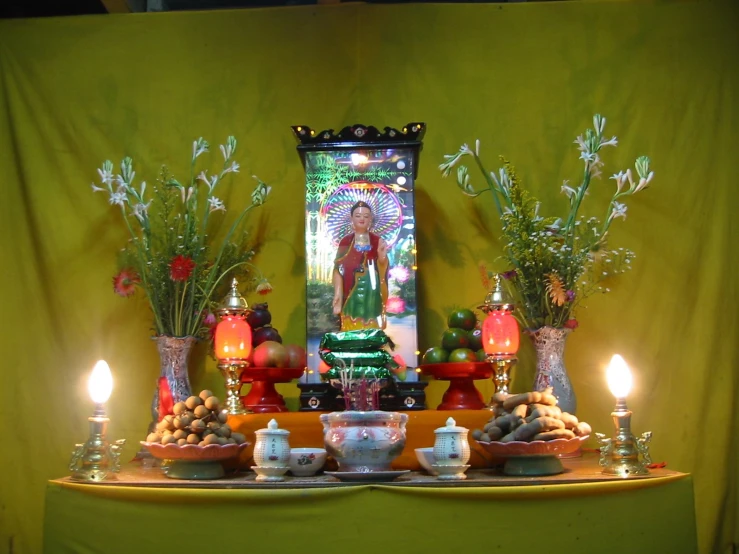 the altar with some candle and a frothy statue