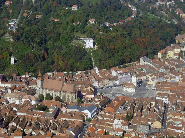 aerial po of old town, with green trees in background