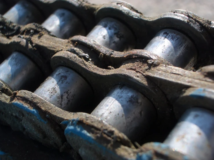 a metal device with several pieces of rusted steel on it