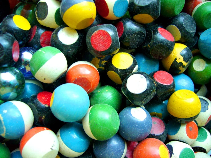 a bunch of colorful balls are laying on the table