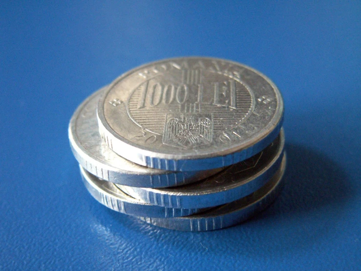 four stacks of mexican one - cents on a blue surface