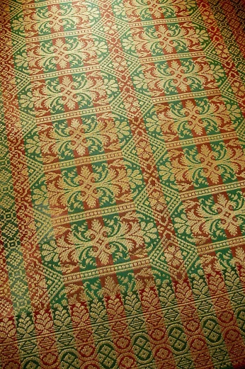 a large area rug with some green and red designs