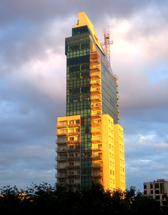 a tall yellow building with lots of windows