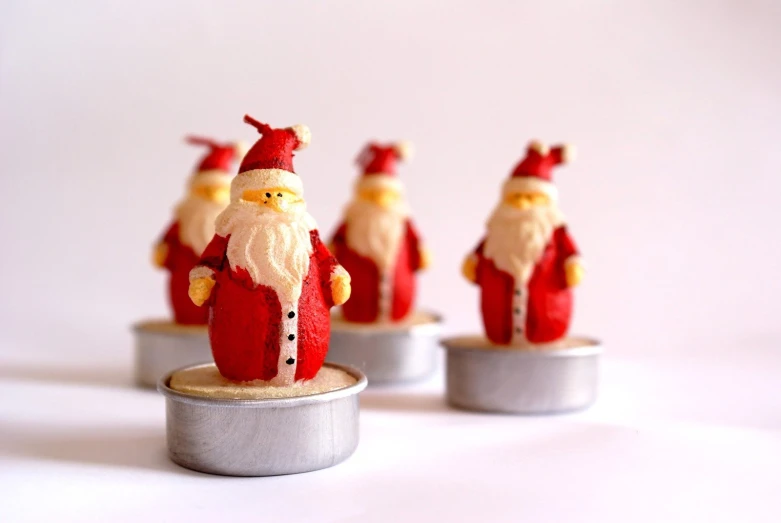 a red and white figurine with many santas