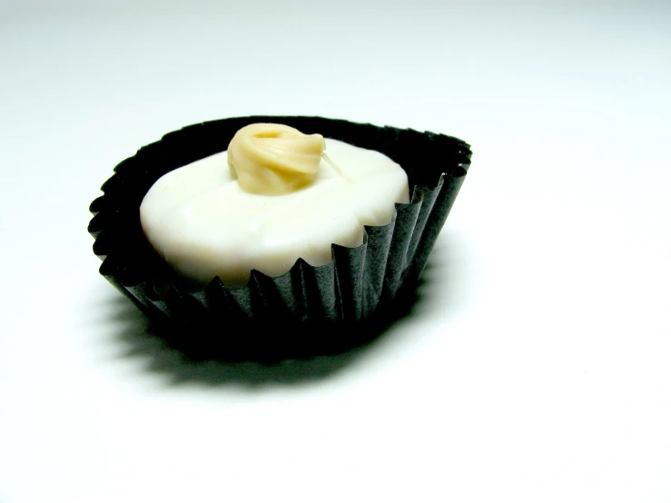 a small piece of chocolate and cream sitting on top of a table