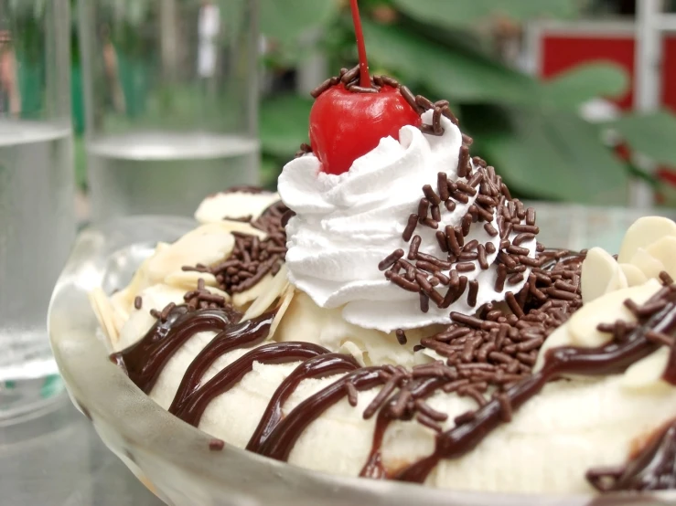 a banana split with whipped cream and a cherry on top