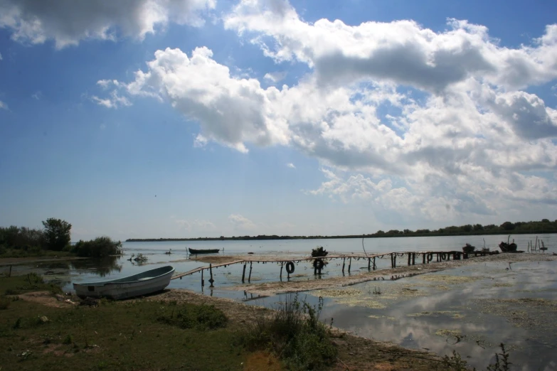 a group of people sitting next to a body of water