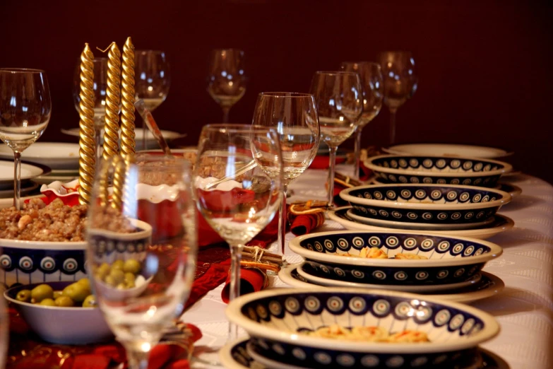 plates, bowls and glasses sitting on a table