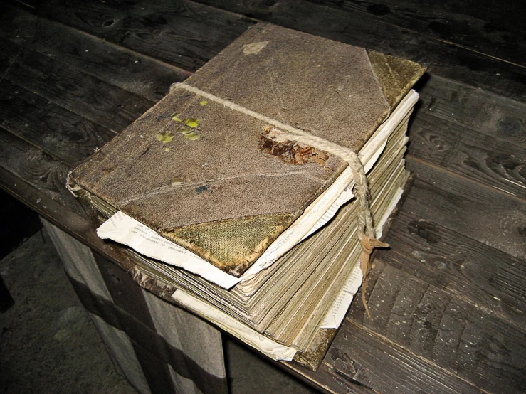 a stack of old books on a wooden table