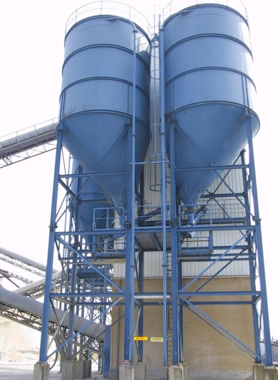 a tall tower with two large blue tanks on top