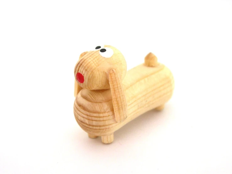 toy wooden dog, in profile, on white background