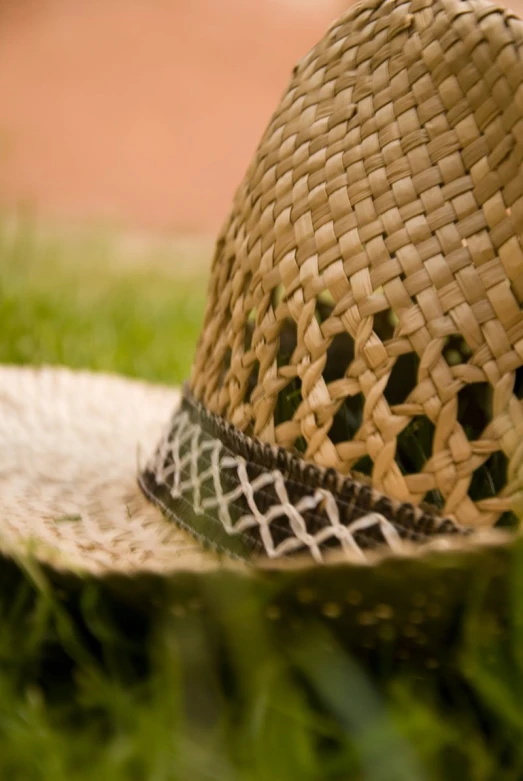 an interesting hat is shown sitting on some grass