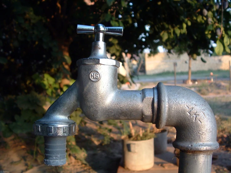 water dripping from an old metallic faucet