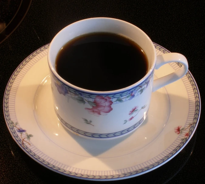 a coffee cup and saucer on a plate