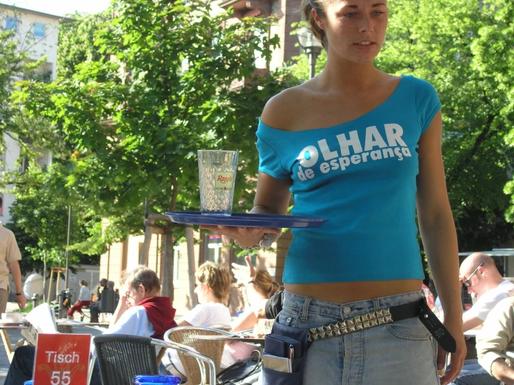 woman carrying a plate of food at an outdoor restaurant