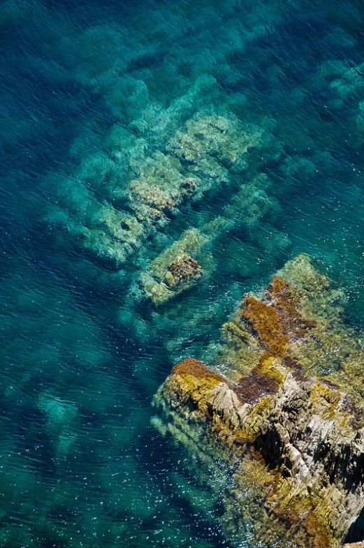 a rocky island next to the ocean