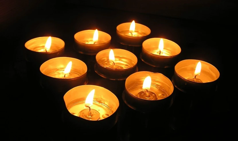 a group of lit candles sitting on top of a table