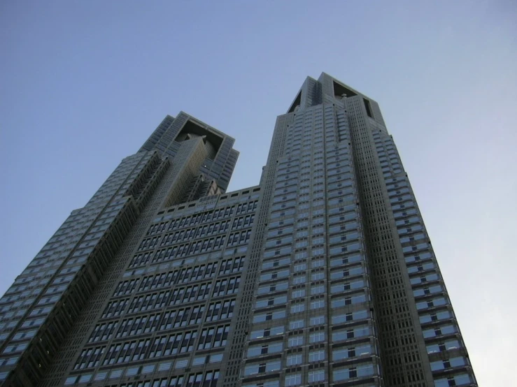 the top of two tall buildings with some windows