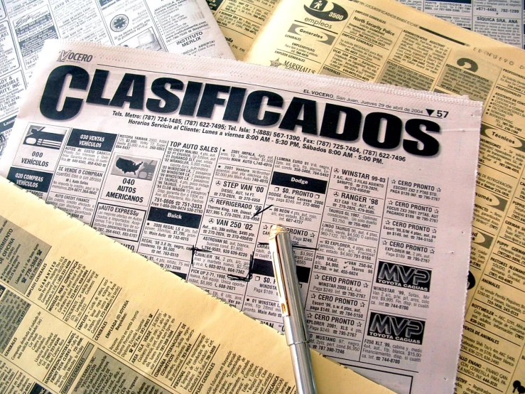 newspaper papers with words classifiedos on them