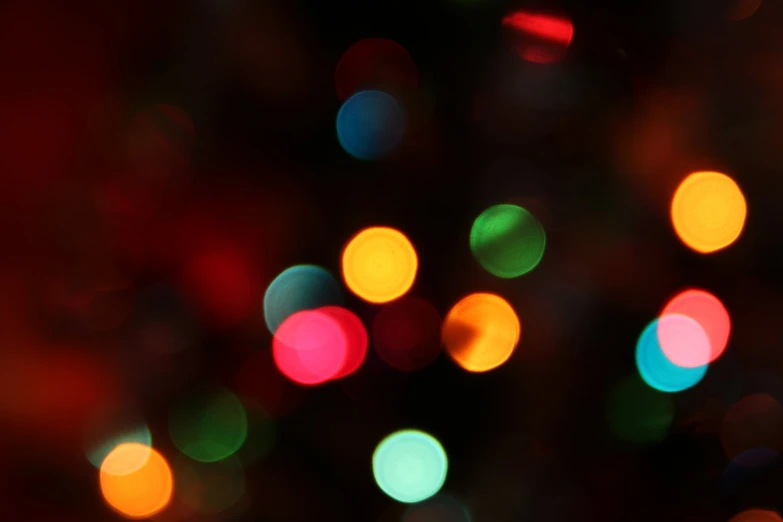 brightly colored lights in black background, focused on the green