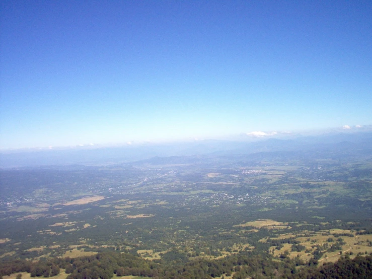 the view from the plane shows a forest and a valley