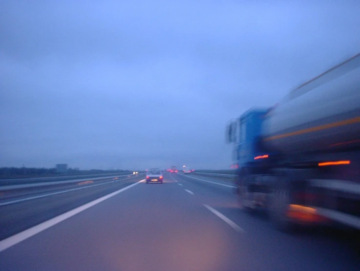 the truck is driving down the highway in traffic