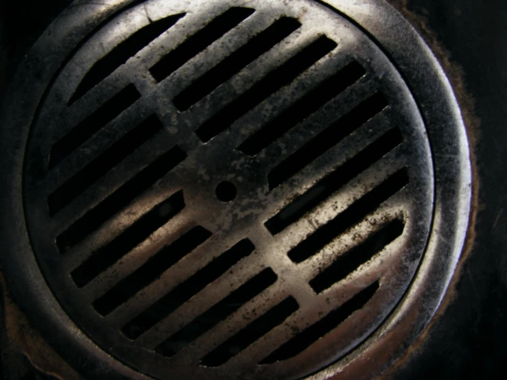 an iron grate cover on top of a sink
