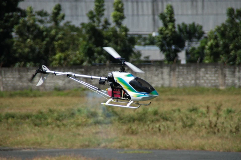 a small helicopter flying through a cloudy sky