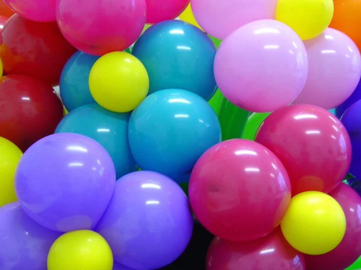 a bunch of balloons that are grouped together