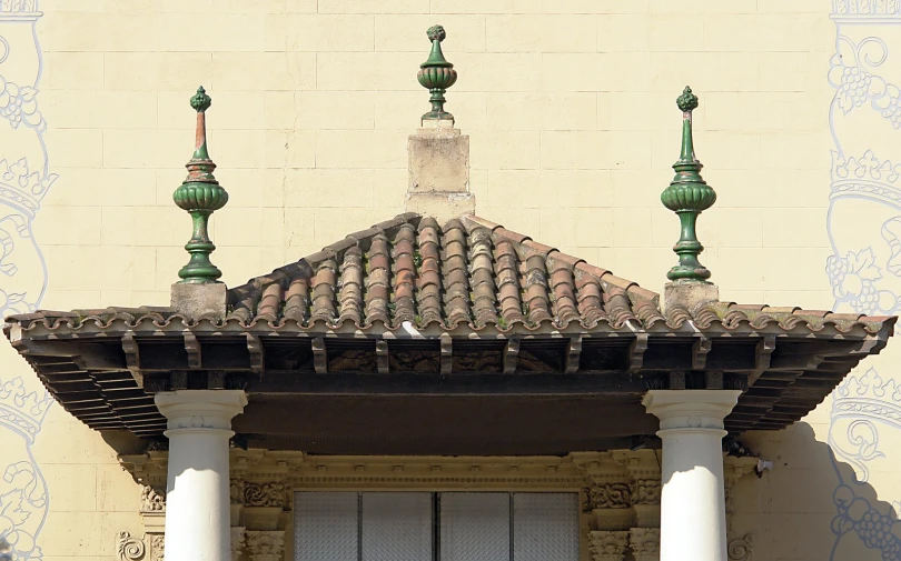 a large building with pillars and some doors