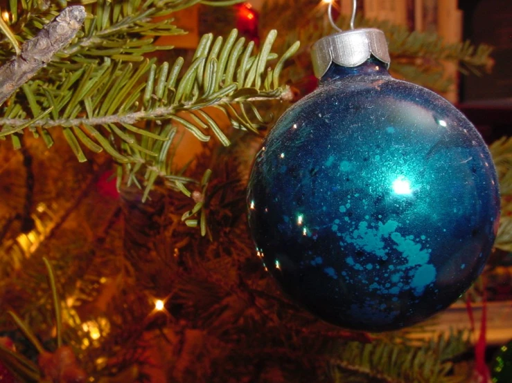 a close up of a christmas ornament hanging from a tree