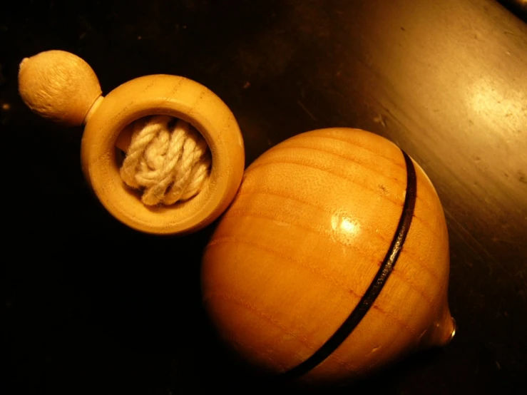 a wooden toy with an acorn inside on a table