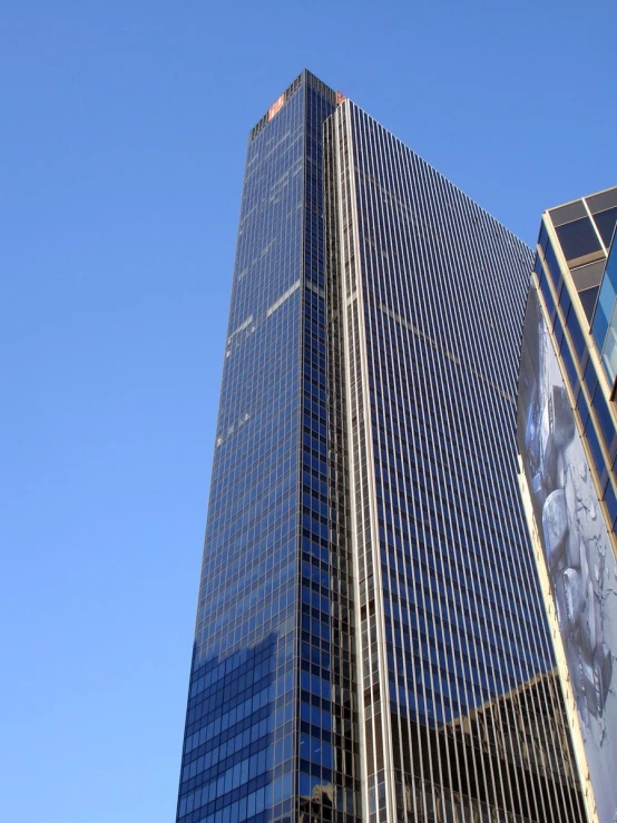 a tall skyscr with a very blue sky in the background