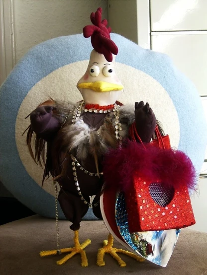 the chicken is holding two bags in one hand and wearing a feathery headdress