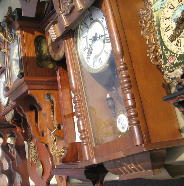 a brown grandfather clock with a white face