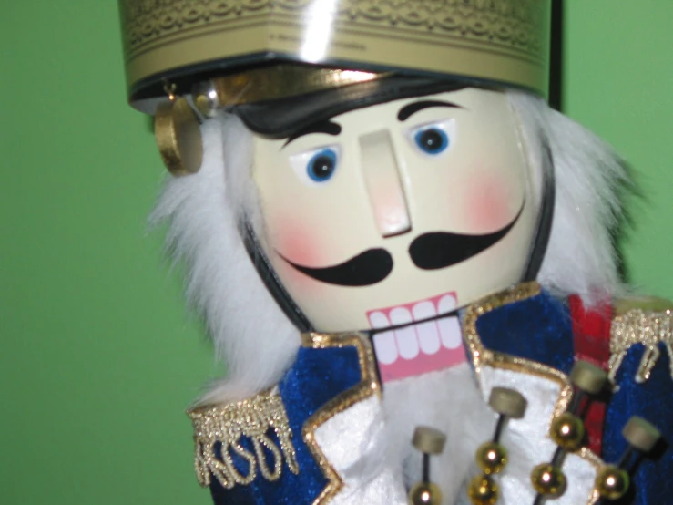 a toy soldier is decorated in gold and blue