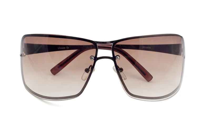 a pair of brown glasses that are on top of a white surface