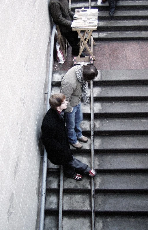 a group of people that are standing on some stairs