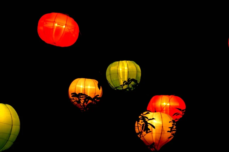glowing red, yellow, green and orange chinese lanterns