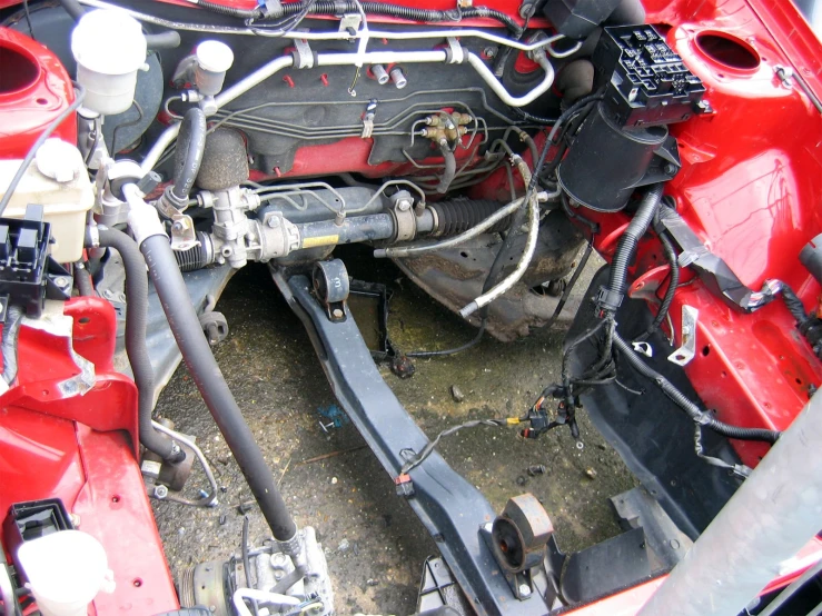 the engine compartment of an old red truck