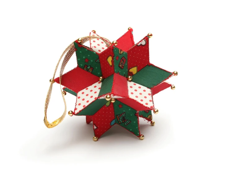 a red, green and gold ornament with christmas decorations