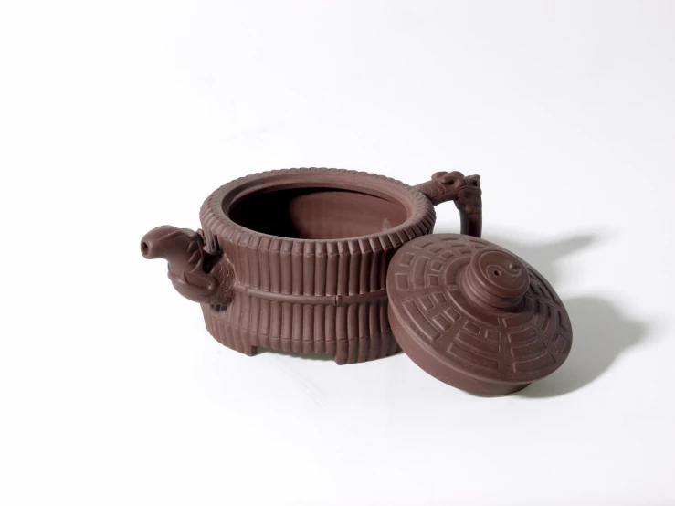 two brown pottery items are on display on a table