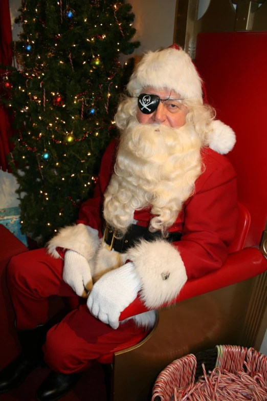 a santa claus sitting in his christmas chair