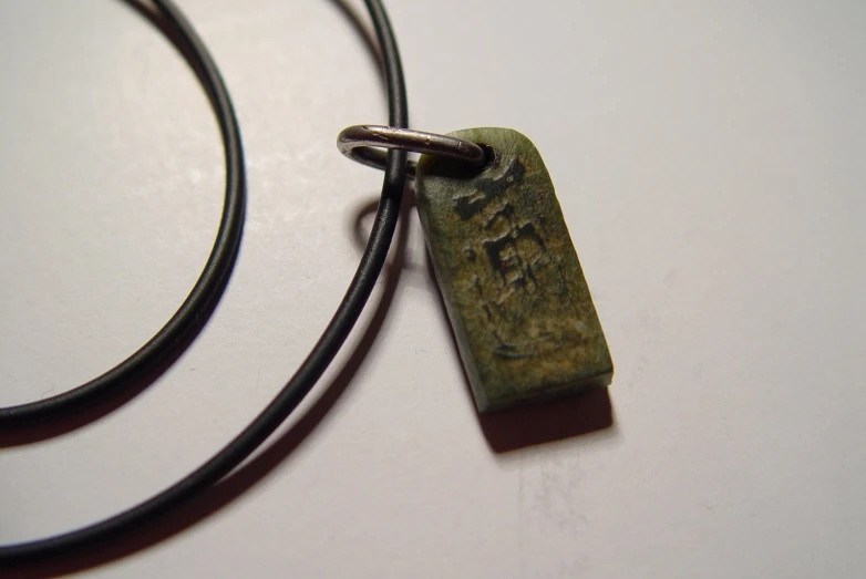 this necklace has a small rectangular metal clasp that leads to an opening